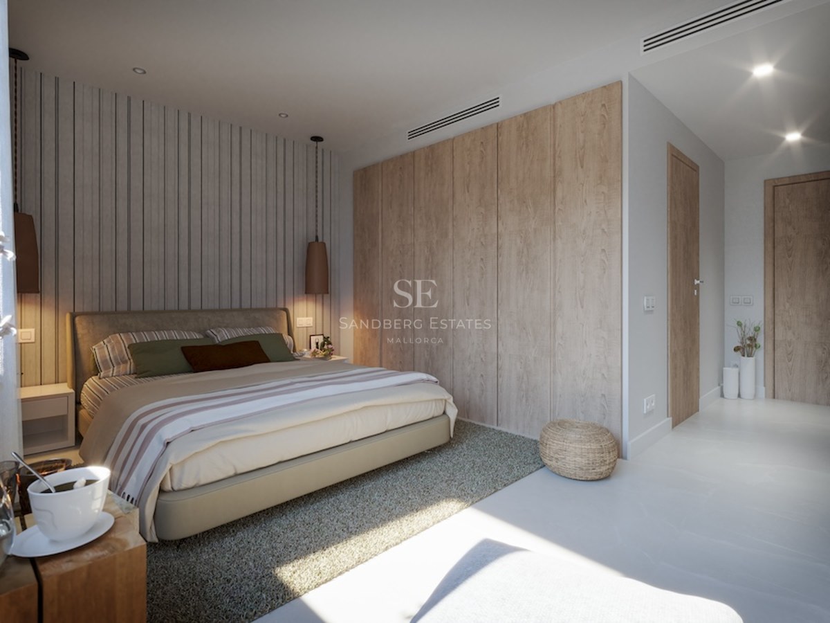 Modern bedroom featuring a large bed, light wood built-in wardrobes, a striped accent wall, and designer pendant lights.