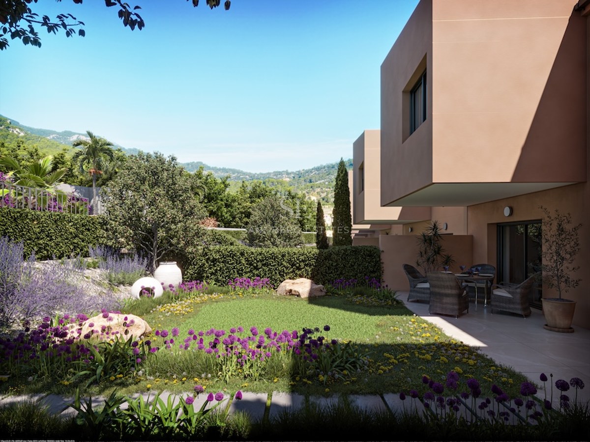 Landscaped garden with purple flowers, lawn, furnished terrace, and modern architecture in a natural setting.