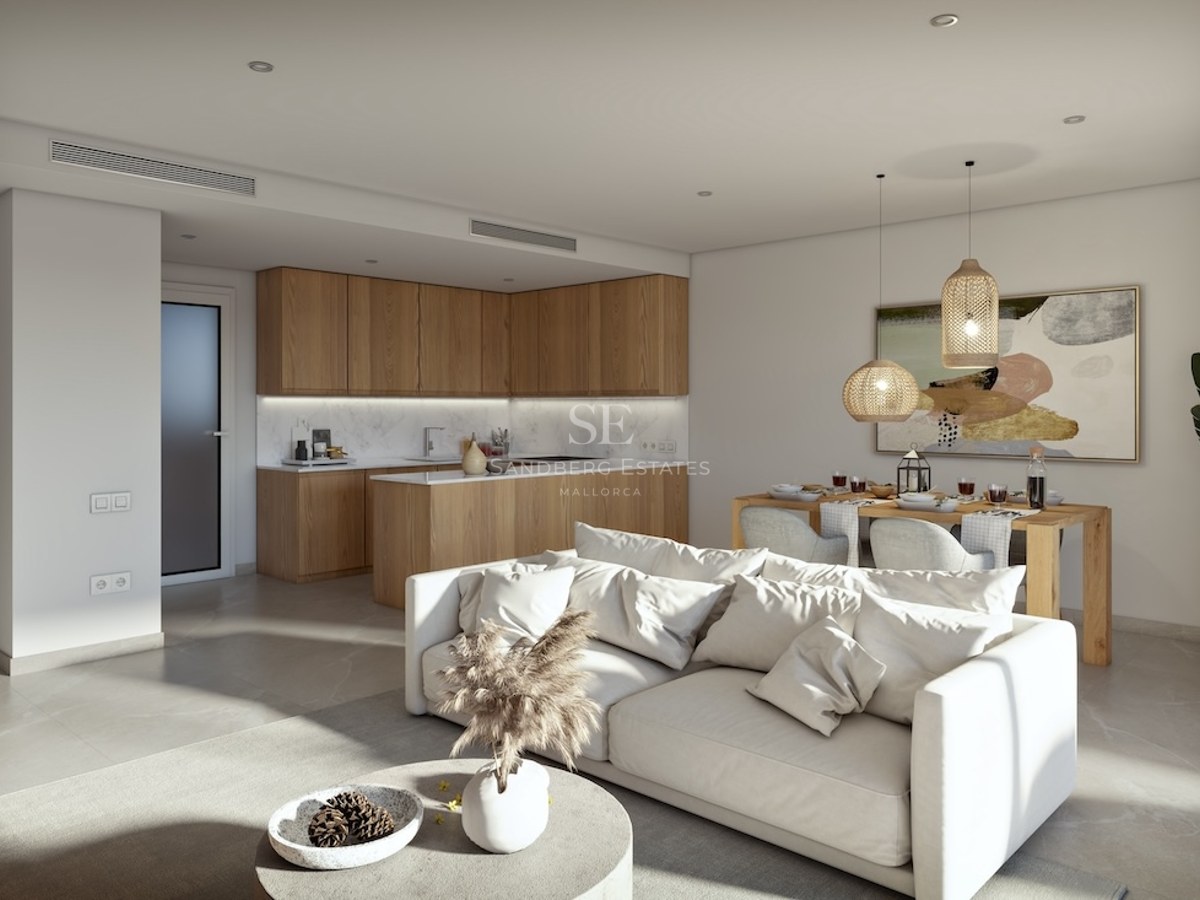 Modern living room with a white sofa, wooden dining table, and contemporary kitchen with wood and marble finishes.