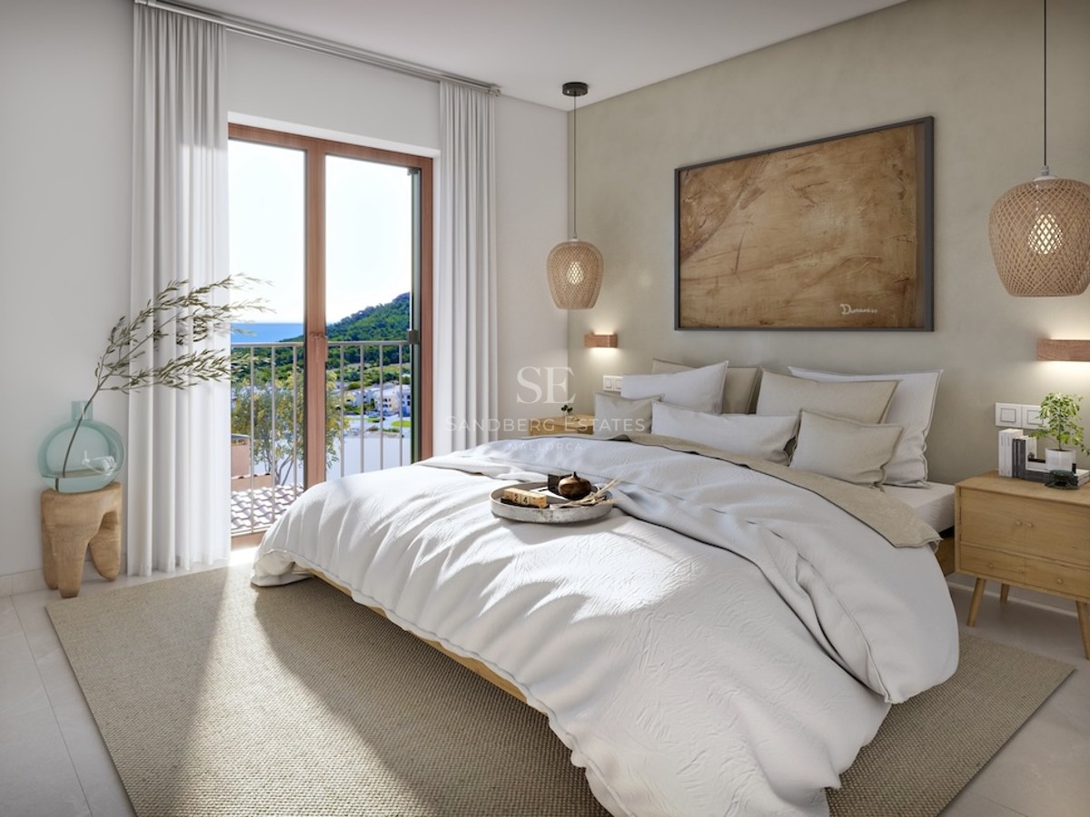 Bright modern bedroom with white bed, wicker lamps, wooden nightstands, and a balcony overlooking the sea and mountains.