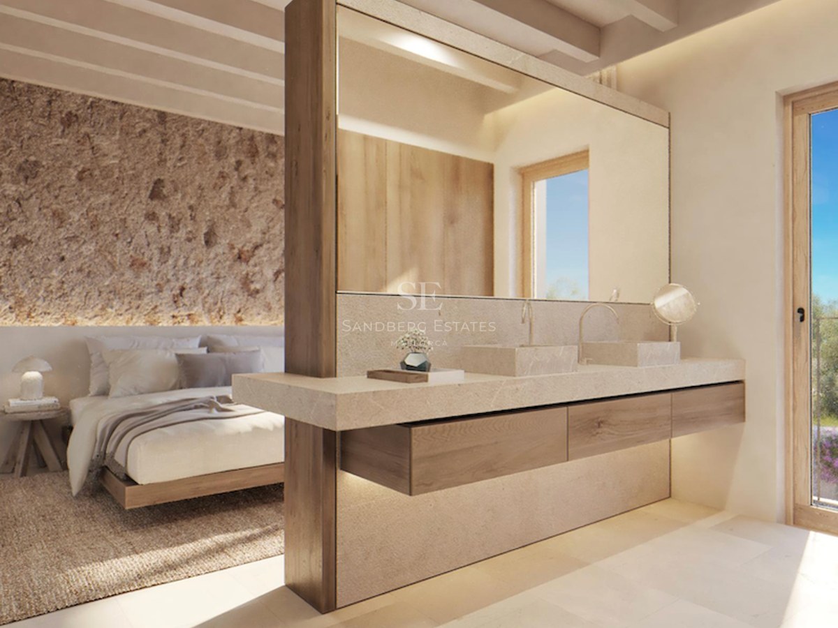 Modern master bedroom with integrated stone double vanity, rustic stone accent wall, and timber-beamed ceiling.