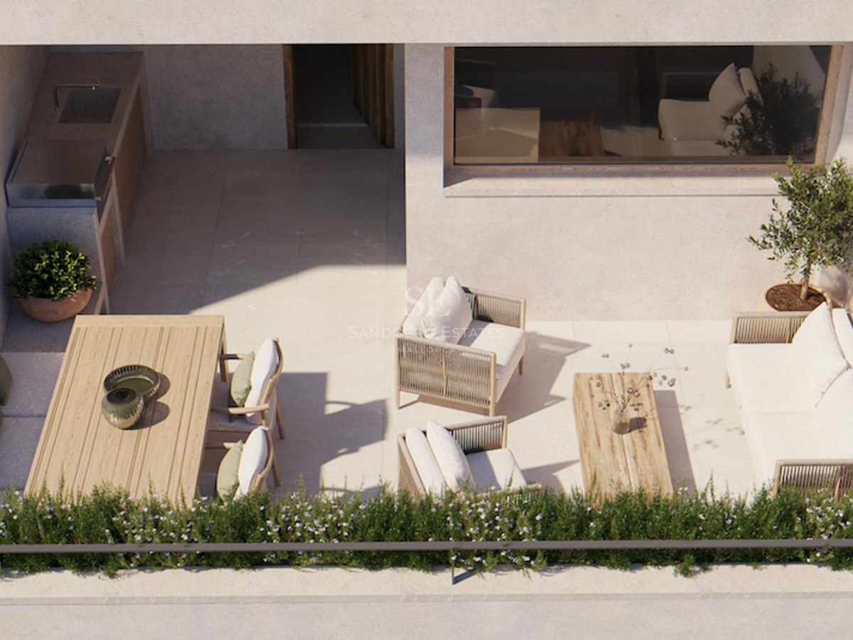 Bird's eye view of a sunlit modern terrace featuring a lounge area, dining table, and outdoor kitchen with a grill.