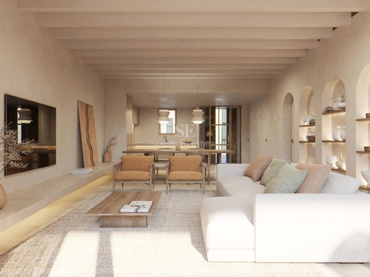 Bright living room with white sofa, wooden ceiling beams, and arched wall niches displaying ceramic pottery.