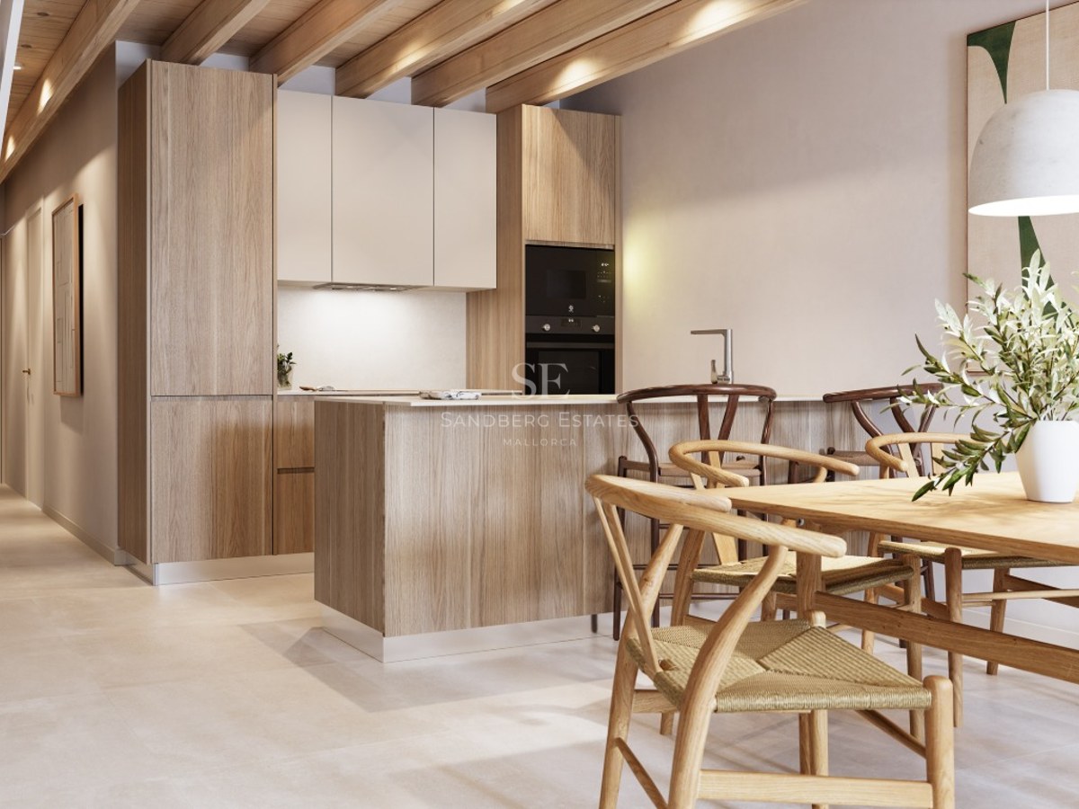 Modern kitchen featuring exposed wooden ceiling beams, a central island with stools, and an adjacent wooden dining table.