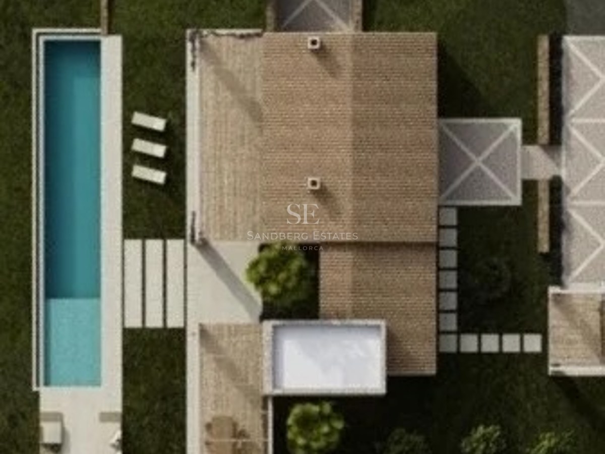 Top-down aerial view of a luxury villa featuring a long turquoise pool, lush green lawn, and stone terraces.