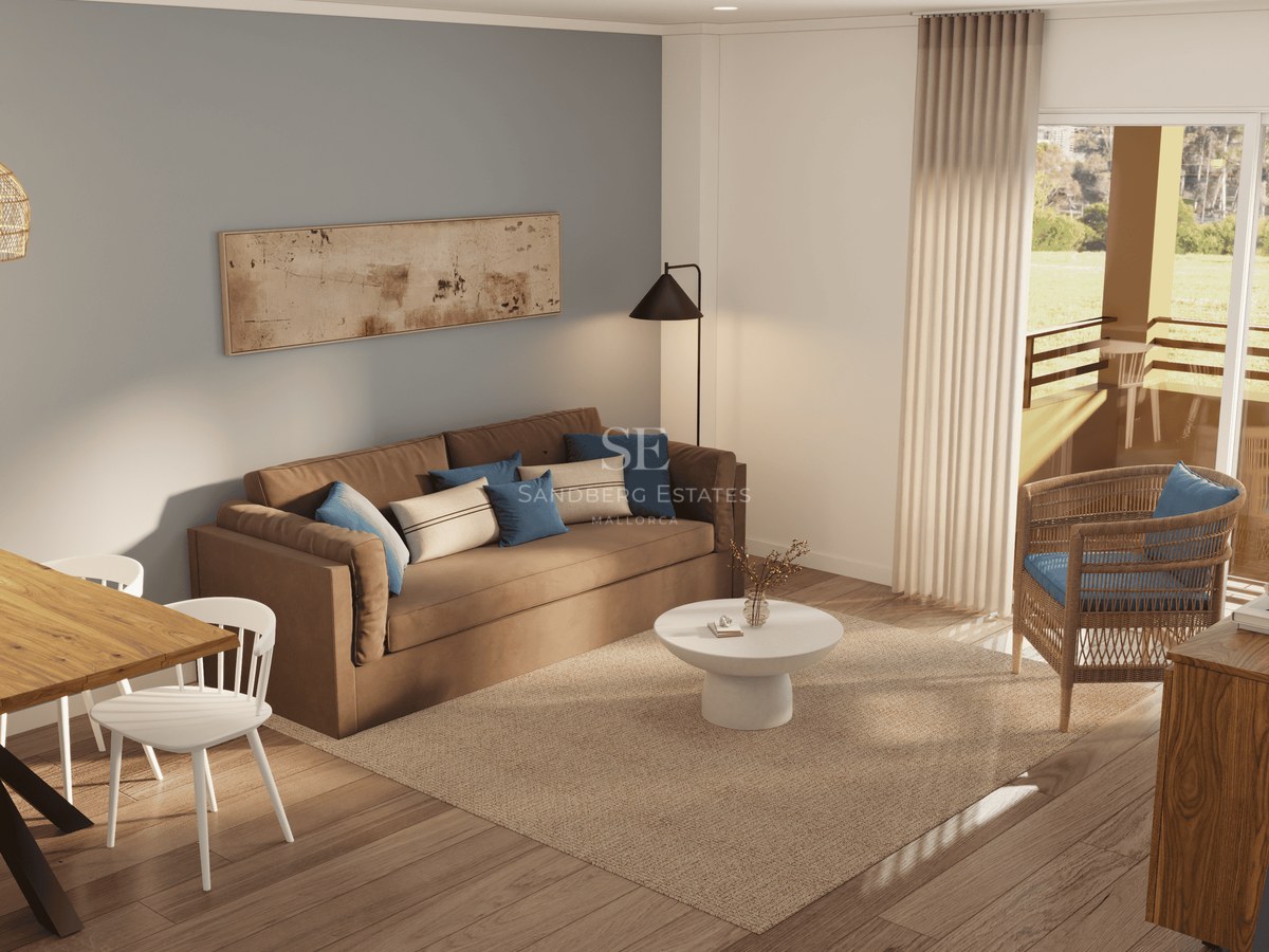 Living room featuring a brown sofa, wicker chair, jute rug, and glass doors leading to a sunny balcony.
