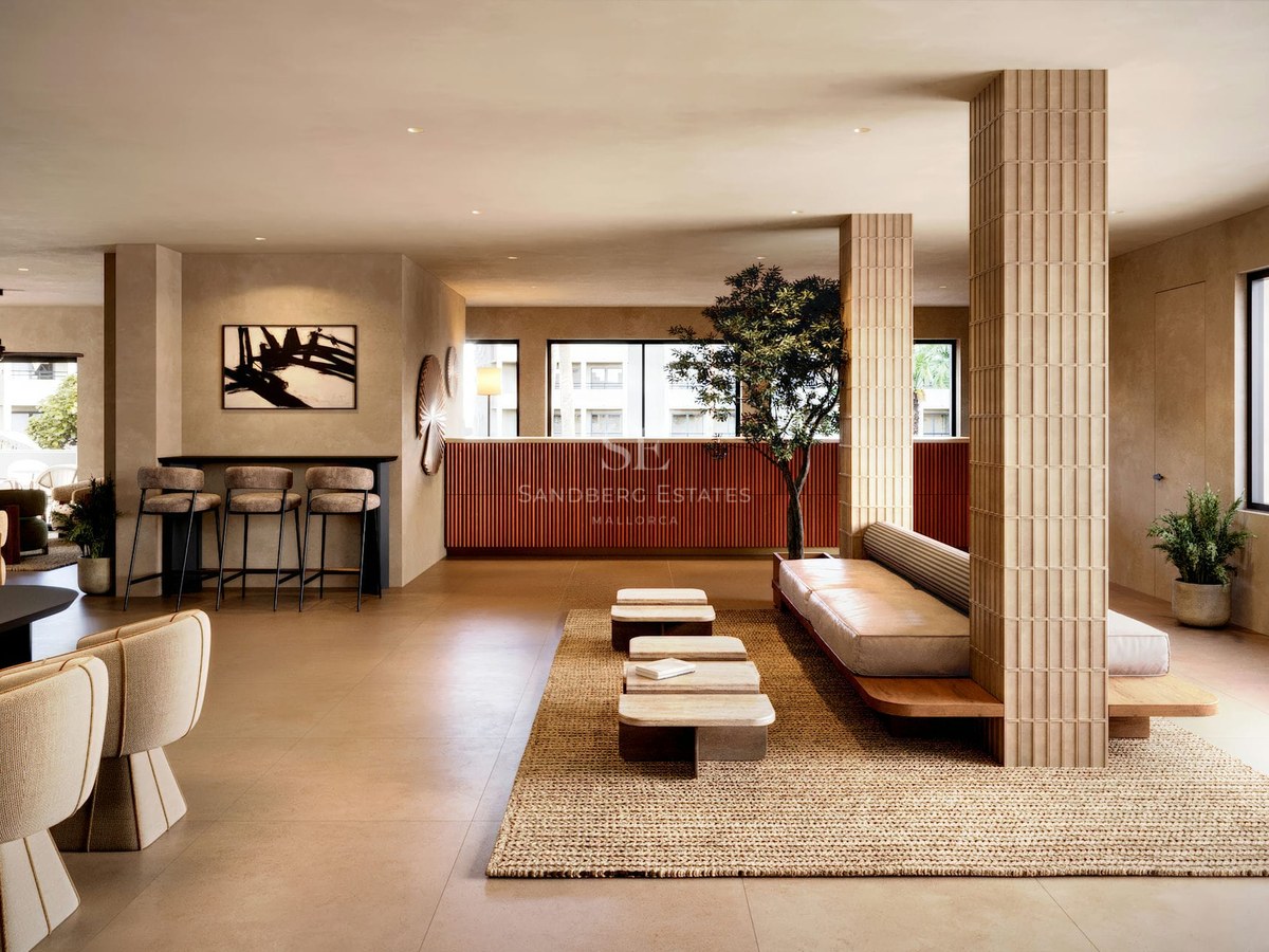 Contemporary lobby with fluted wood pillars, a leather daybed, travertine tables, and warm terracotta accents.