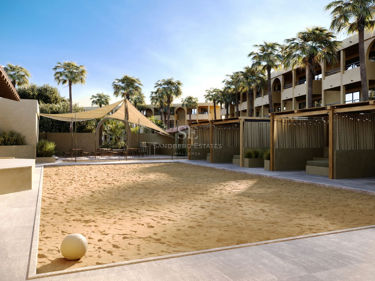 A professional sand volleyball court with a volleyball in the foreground, palm trees, and shaded wooden cabanas.