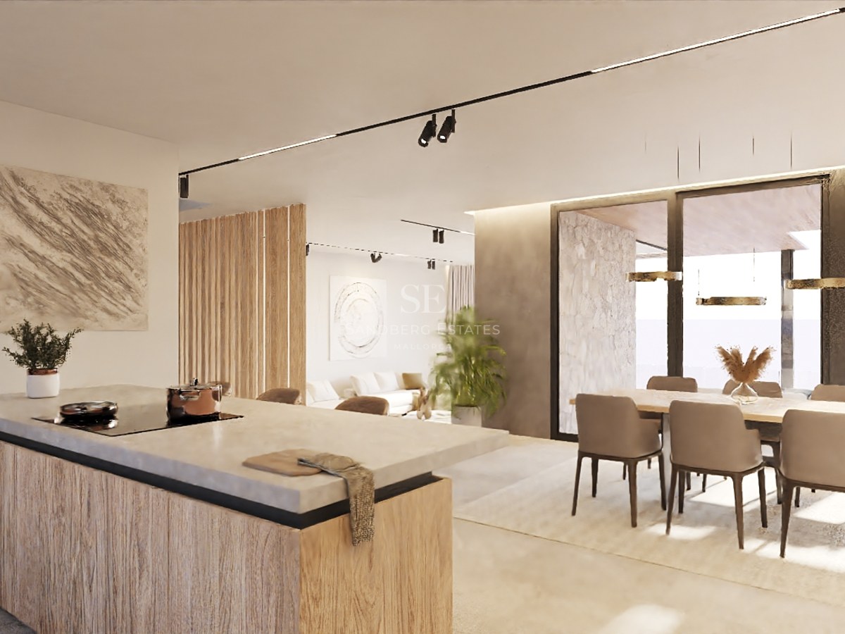 Cuisine moderne avec îlot en pierre, accents en bois et grandes baies vitrées dans une résidence de luxe.