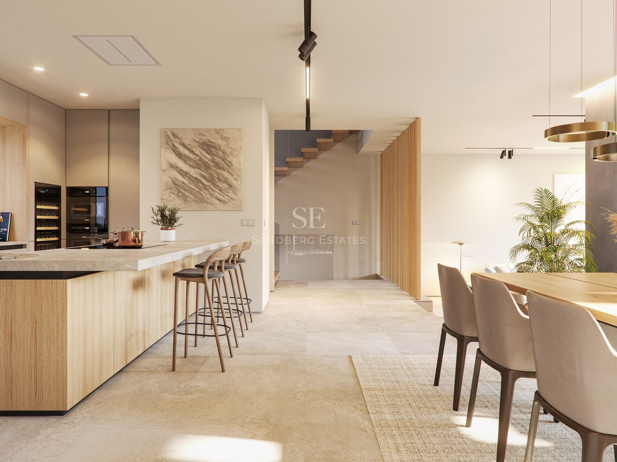 Cuisine contemporaine avec îlot en bois, sol en pierre naturelle et escalier minimaliste en arrière-plan.