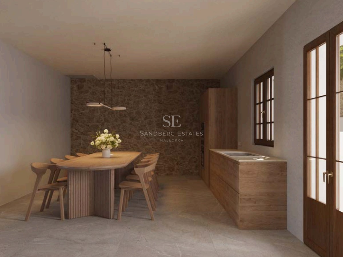 Modern dining room featuring a large oval oak table, eight chairs, a textured stone wall, and natural side lighting.