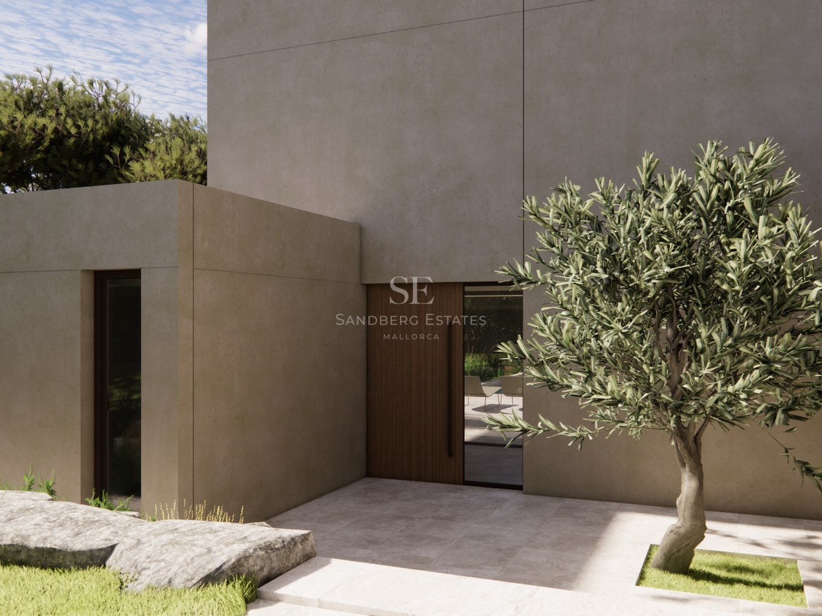 Entrée de villa moderne avec murs en béton beige, porte en bois et un olivier dans une cour en pierre.