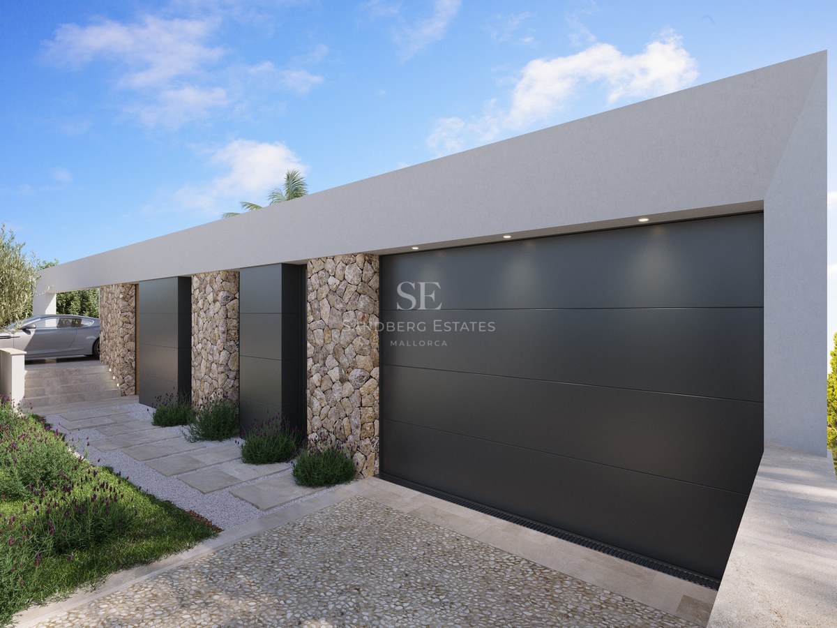 Extérieur de villa contemporaine avec grandes portes de garage anthracite et murs en pierre naturelle apparente.