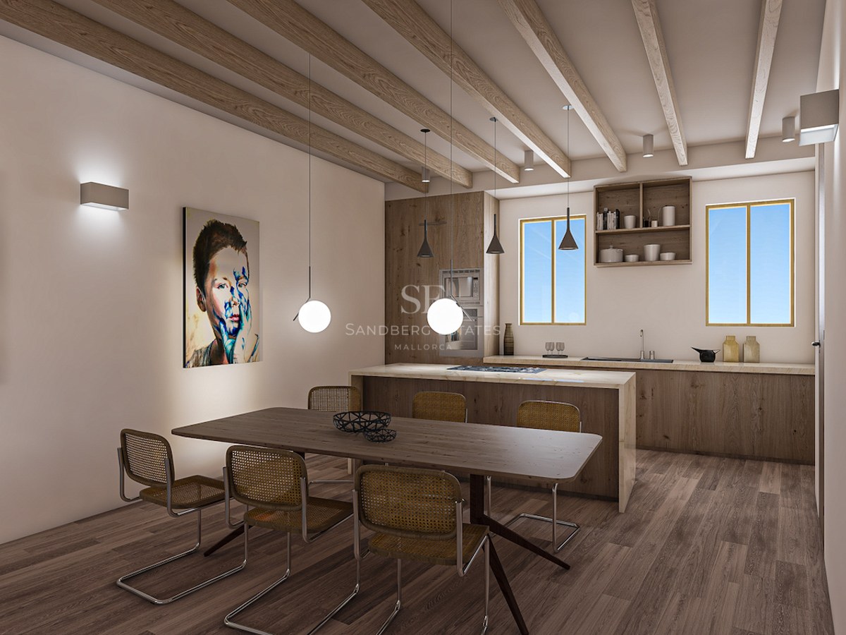 Modern kitchen with wooden ceiling beams, marble island, wood cabinetry, and a dining table with rattan chairs.