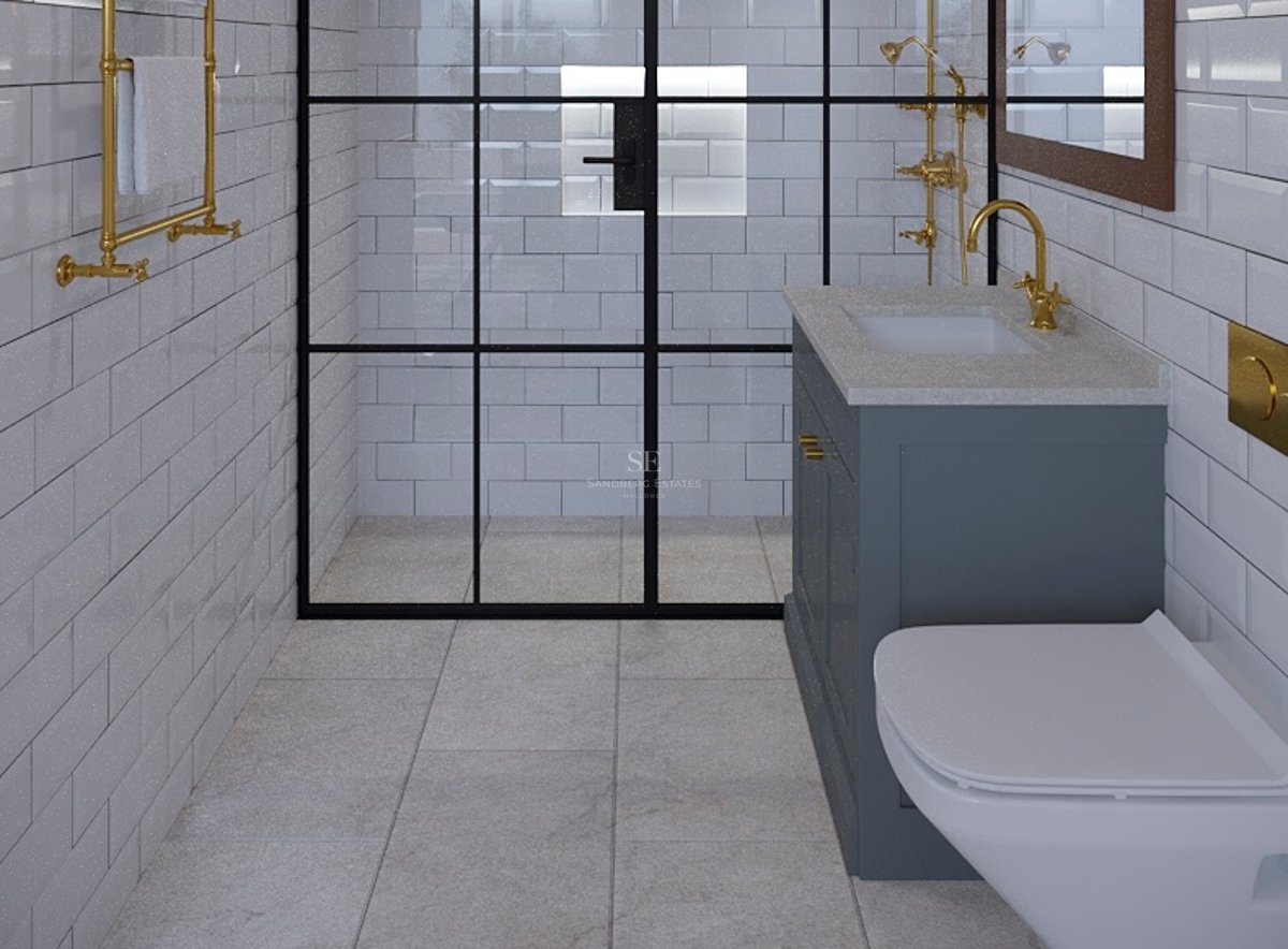 Salle de bain moderne avec carrelage métro blanc, douche à cadre noir et robinetterie dorée élégante.