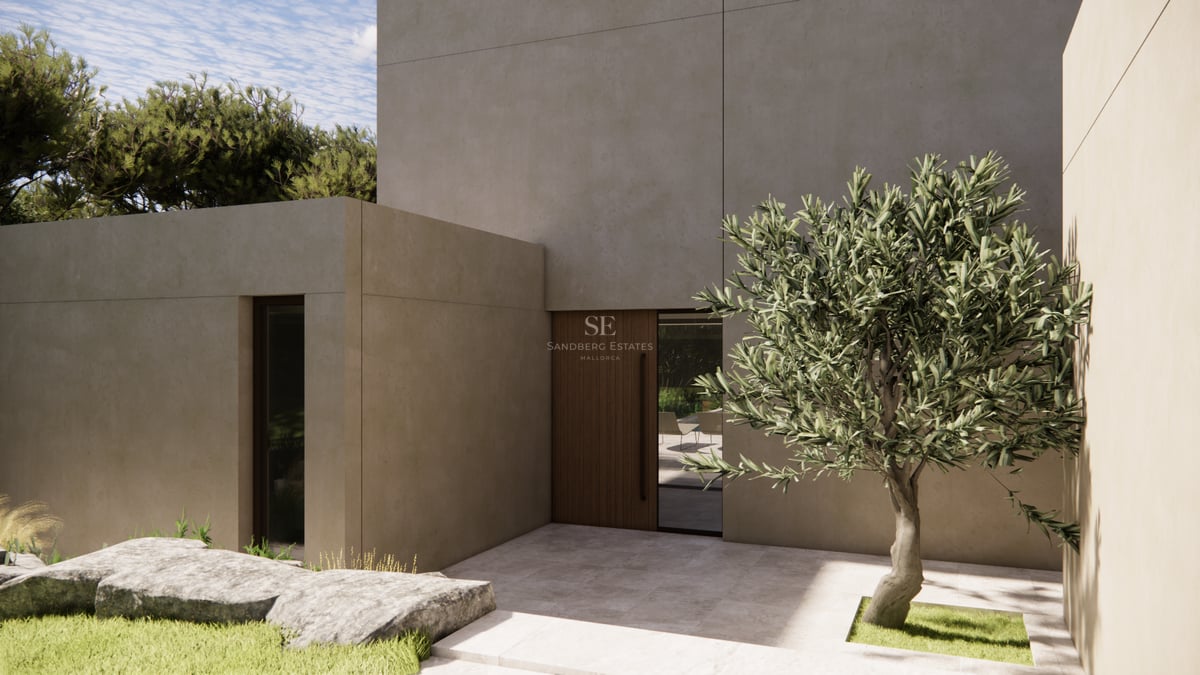 Entrée de villa moderne avec murs en béton beige, porte en bois et un olivier dans une cour en pierre.