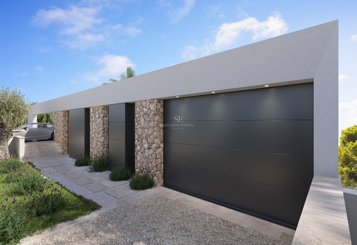 Extérieur de villa contemporaine avec grandes portes de garage anthracite et murs en pierre naturelle apparente.
