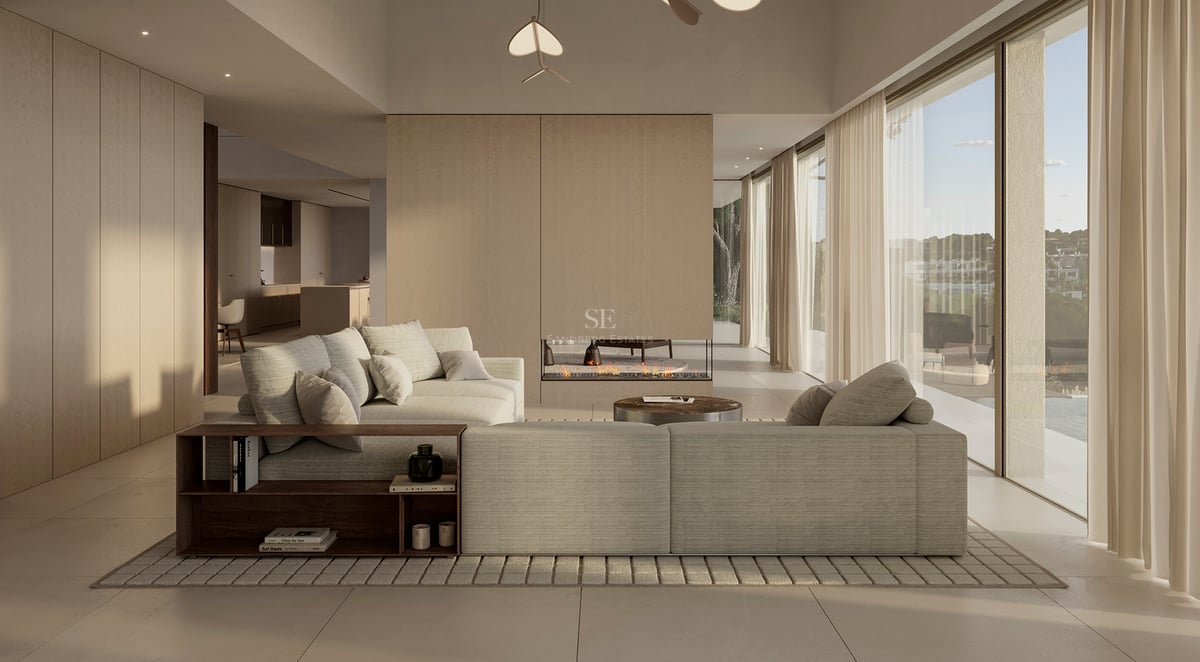 Salon de luxe minimaliste avec un grand canapé d'angle beige, cheminée linéaire et baies vitrées toute hauteur.