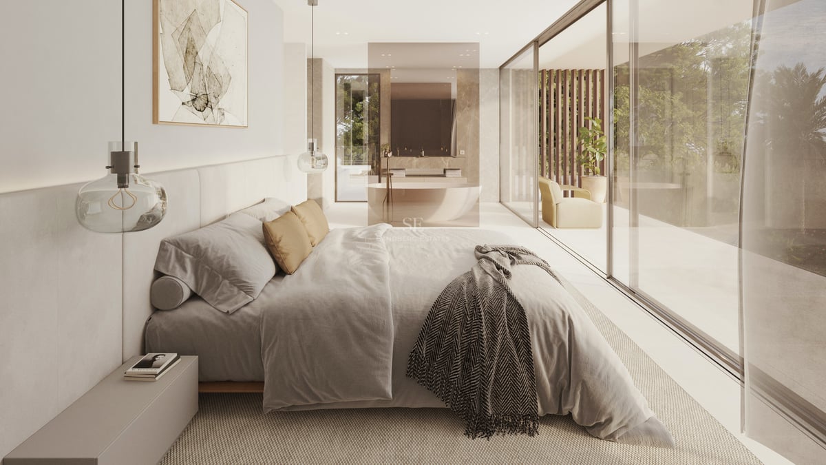 Chambre moderne avec grand lit, parois vitrées donnant sur une terrasse, et salle de bain ouverte avec baignoire îlot.