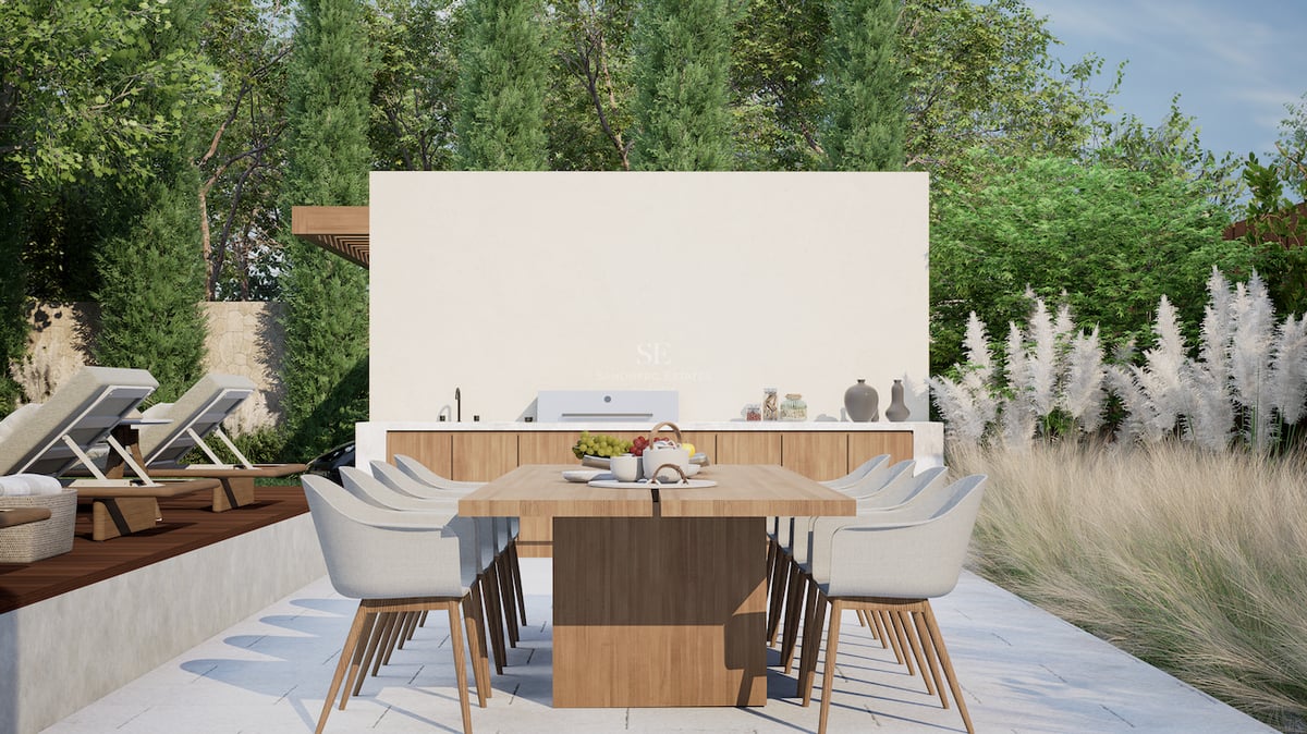 Espace repas extérieur moderne avec table en chêne, cuisine intégrée et bains de soleil.