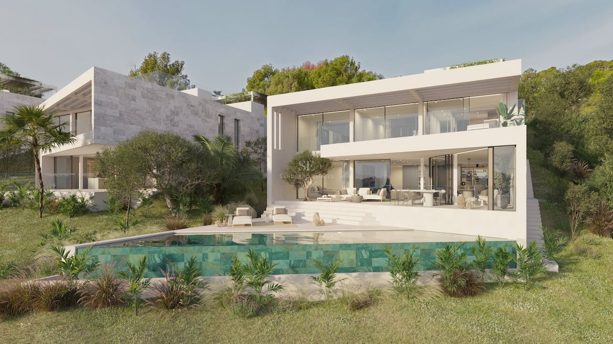 Villa blanche contemporaine avec piscine à débordement, balcons vitrés et jardin méditerranéen.