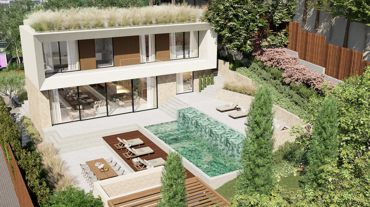 Vue aérienne d'une villa moderne en pierre et blanc avec piscine à plusieurs niveaux et jardin en terrasses.