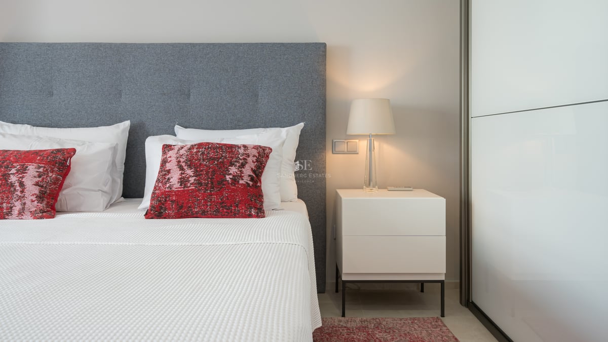 Vaste salon lumineux avec cheminée, baies vitrées panoramiques et décoration minimaliste. Vue sur la mer Méditerranée.