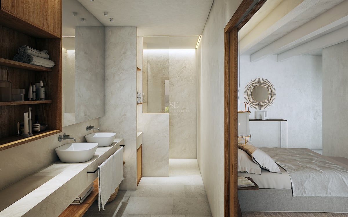 Baño minimalista con lavabos dobles sobre encimera de piedra, estantes de roble y ducha de obra.