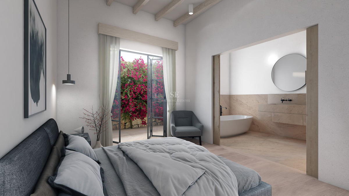 Modernes Schlafzimmer mit Holzbalken, Zugang zum Garten mit Bougainvillea und integriertem Bad mit Badewanne.