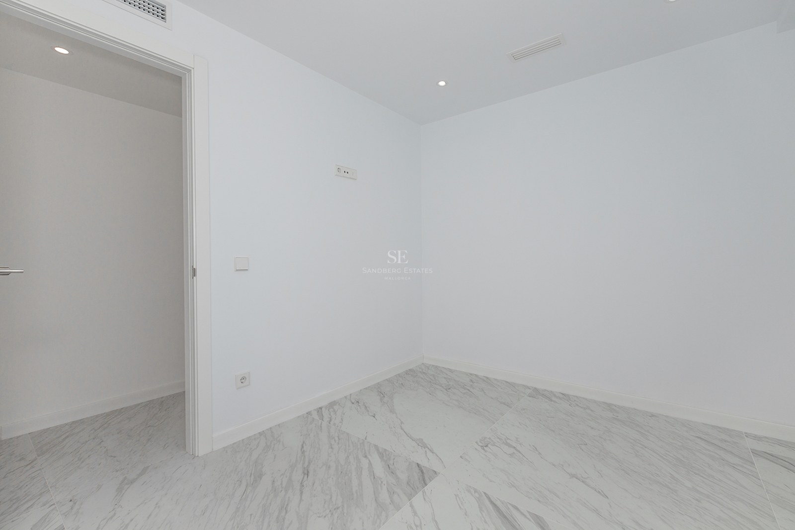 Empty modern room featuring white walls and large-format white marble floor tiles with grey veining.