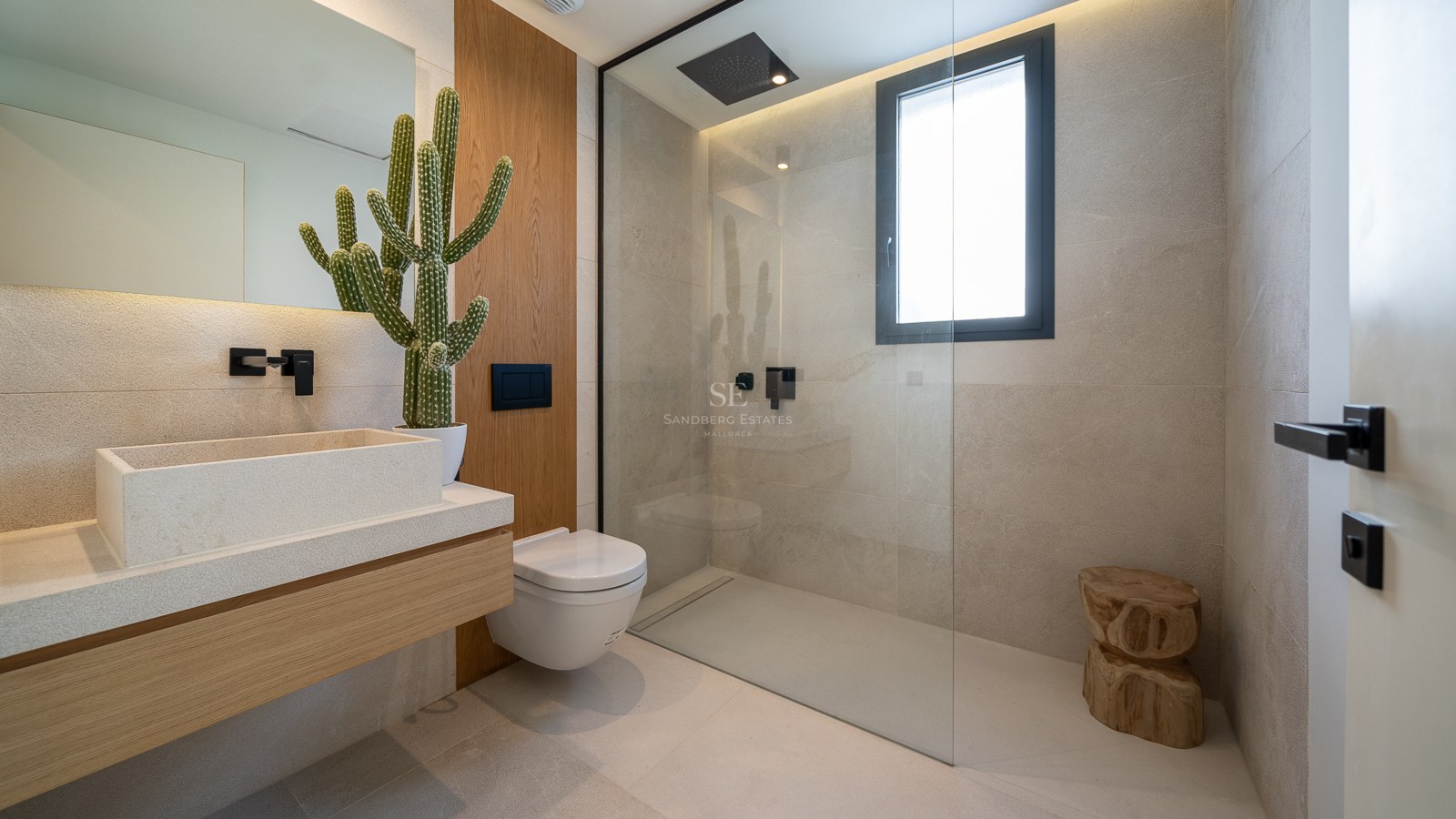 Salle de bains contemporaine avec vasque en pierre, meuble en chêne, douche à l'italienne et robinetterie noire.