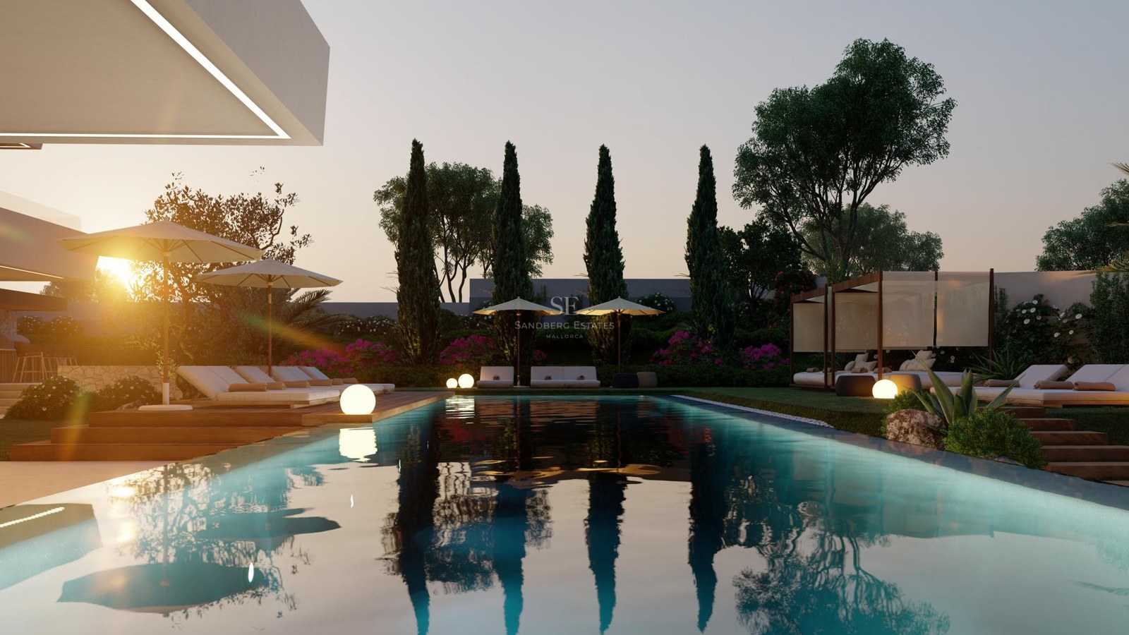 Luxury swimming pool with wood decking, loungers, and glowing sphere lamps at sunset surrounded by cypress trees.