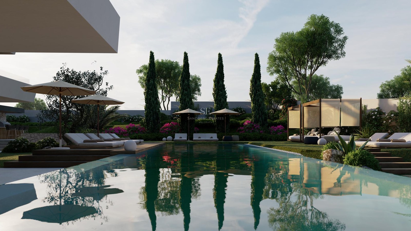Large rectangular swimming pool reflecting cypress trees, surrounded by sunbeds, cabanas, and lush Mediterranean greenery.