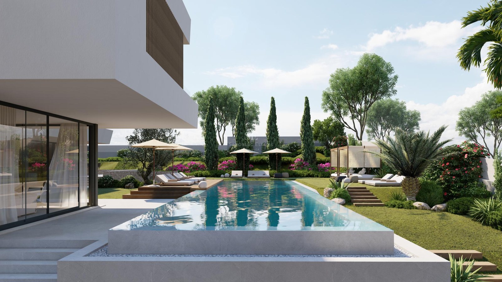 Luxury infinity pool with stone edges overlooking a landscaped garden with sunbeds and a modern white villa.