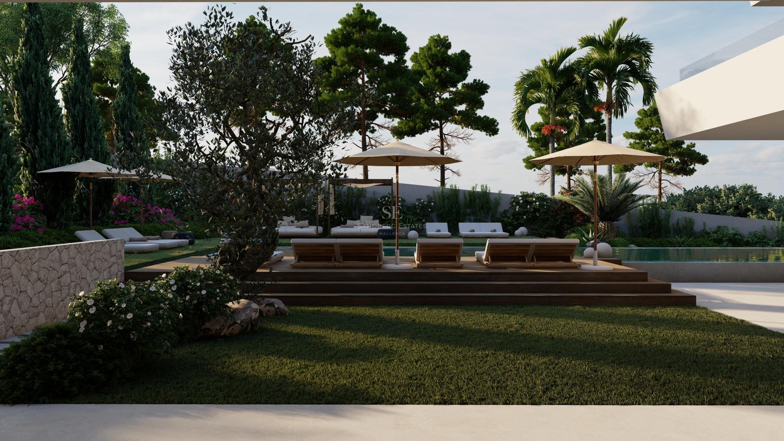Luxury pool area with wooden decking, white sun loungers, and lush Mediterranean landscaping with olive trees.
