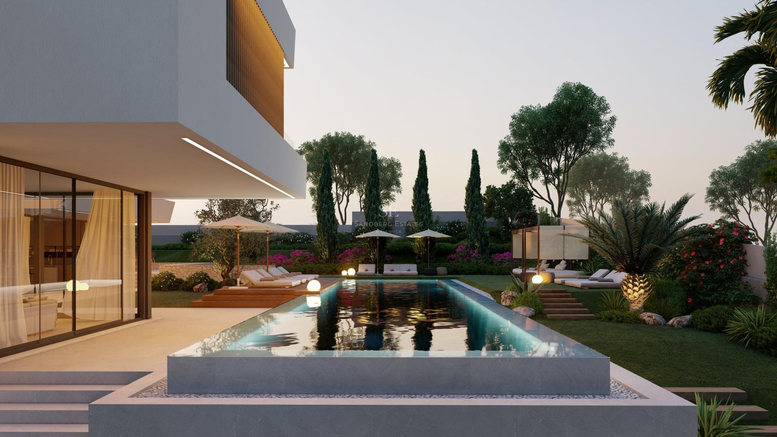 Infinity edge swimming pool with ambient lighting next to a modern white villa and landscaped garden at dusk.