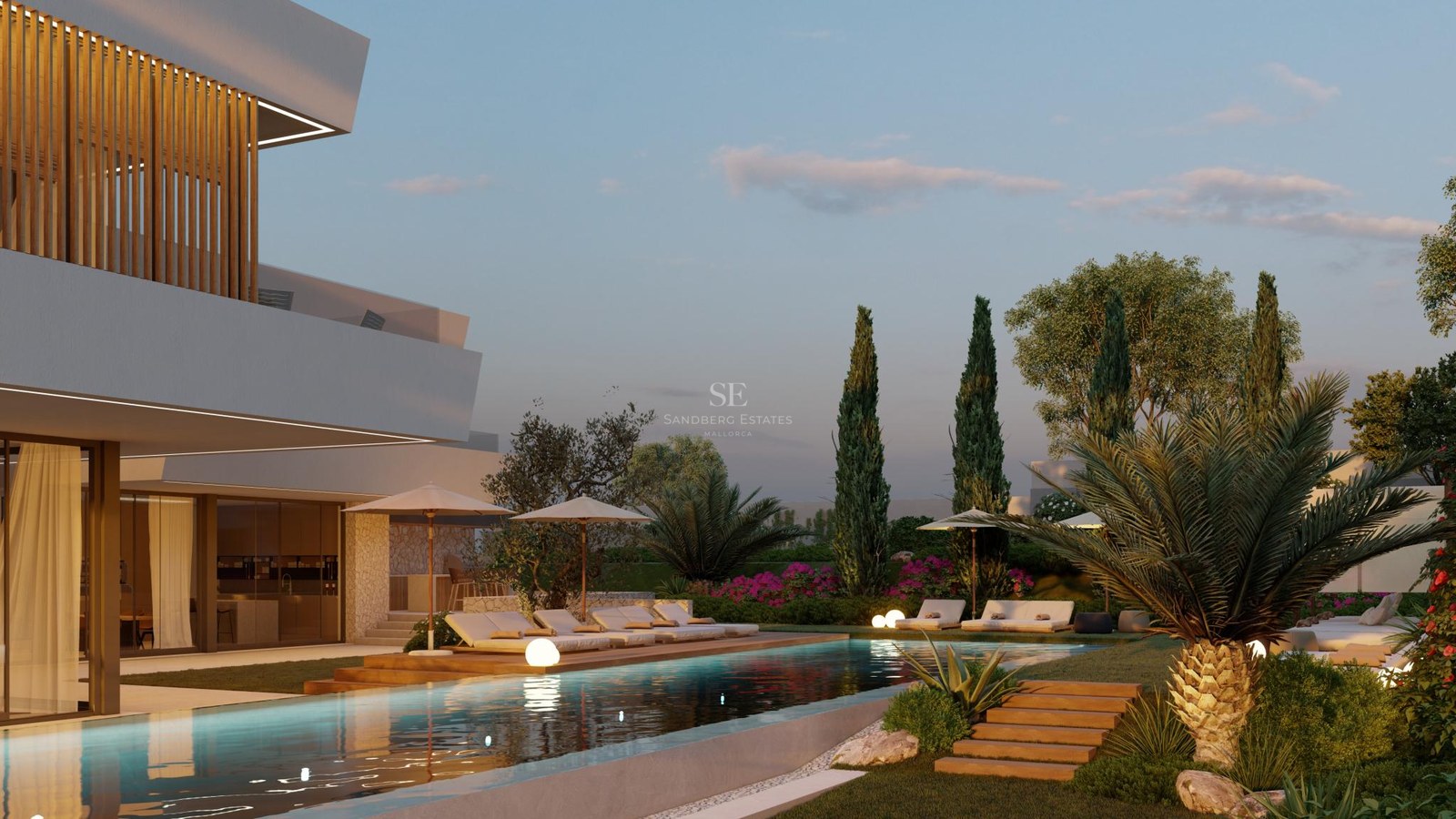 Illuminated lap pool flanked by wooden decking and a modern white villa with Mediterranean landscaping at twilight.