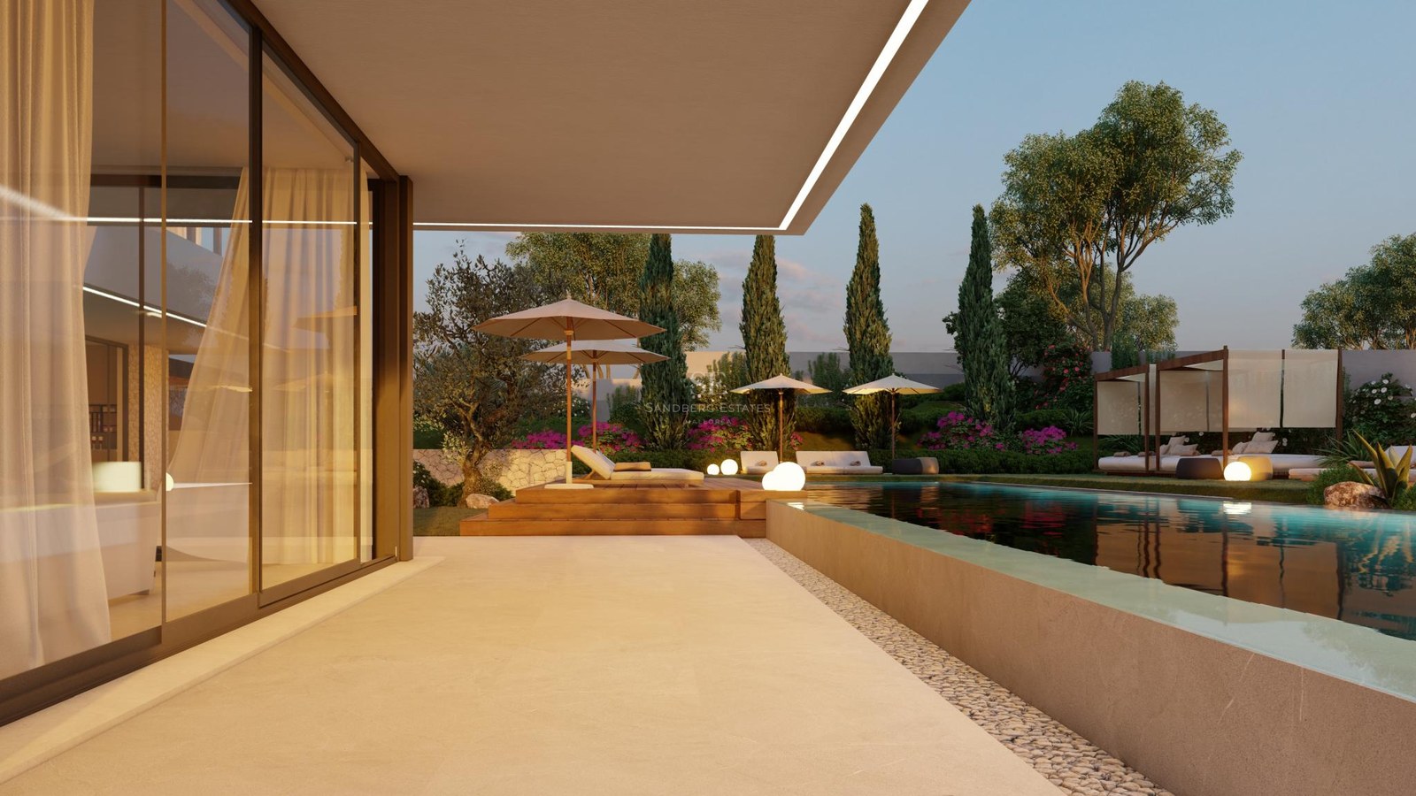 Evening view of a sleek infinity pool and wooden deck beside a modern villa with landscaped Mediterranean gardens.