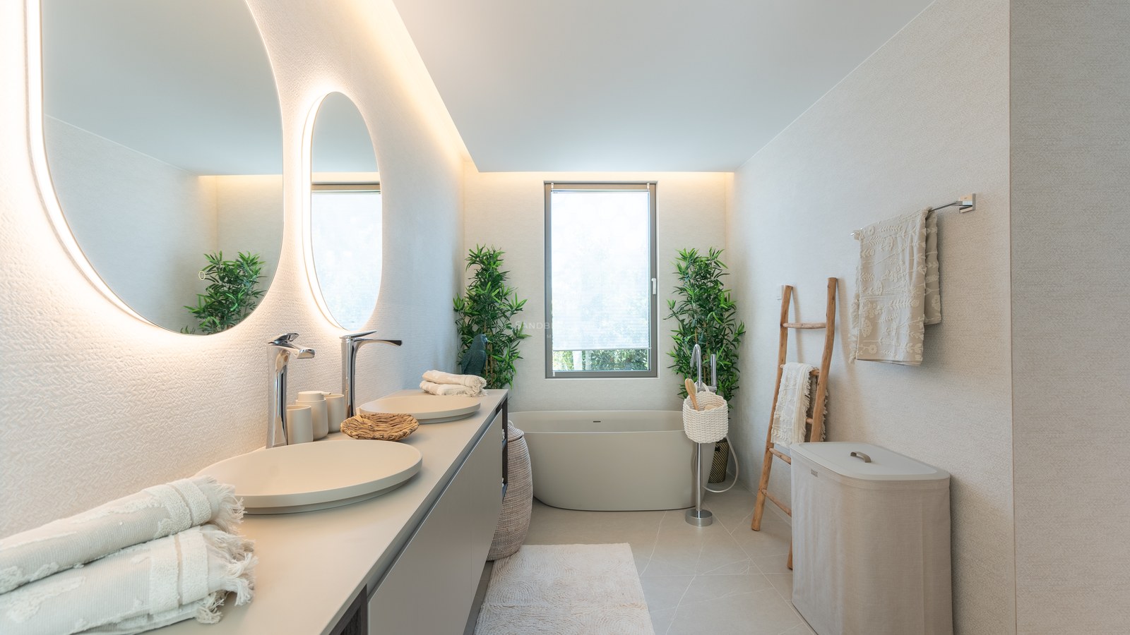 Contemporary master bathroom featuring backlit circular mirrors, dual sinks, a freestanding bathtub, and neutral decor.