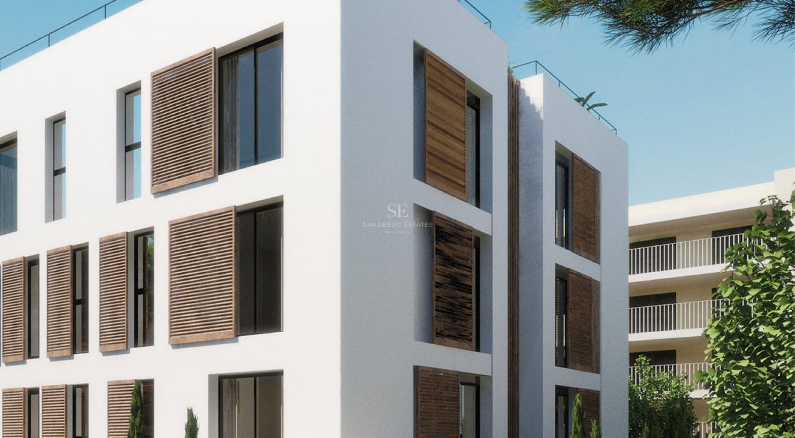 Modern white building with wooden shutters and large glass windows under a clear blue sky.