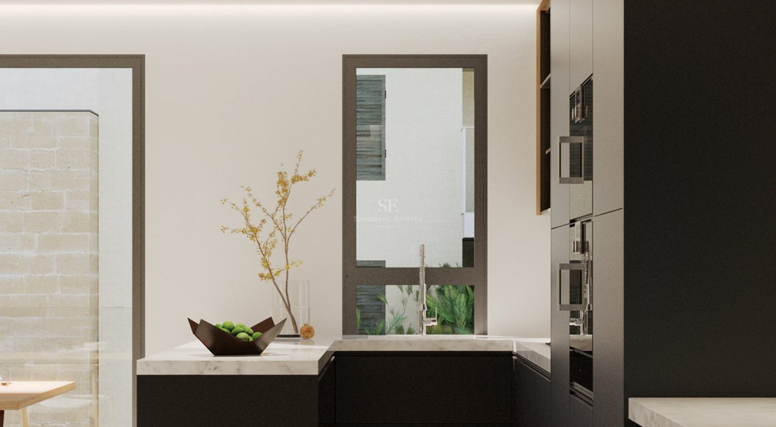 Minimalist kitchen with black cabinets, white marble counters, and a view to an outdoor courtyard.