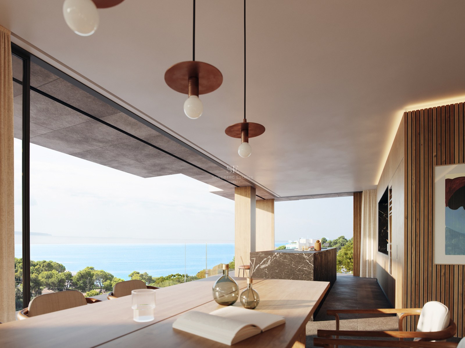 Interior of a luxury dining room with a wooden table and marble island overlooking the Mediterranean sea and pine trees.