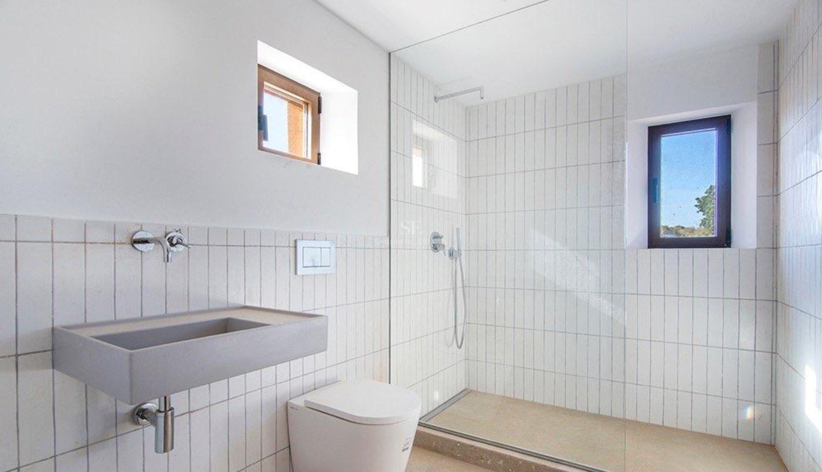 Contemporary bathroom featuring a walk-in shower with glass screen, vertical white tiles, and a gray stone sink.