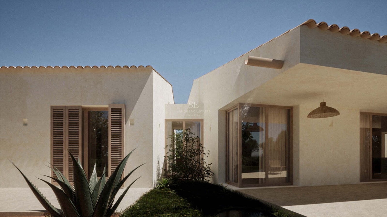 White villa exterior with terracotta roof tiles, wooden shutters, and large windows under a clear blue sky.