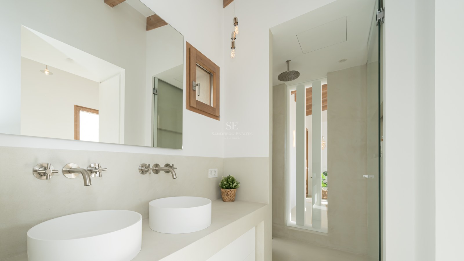 Contemporary bathroom featuring two vessel sinks, wall-mounted chrome faucets, and a walk-in rain shower.
