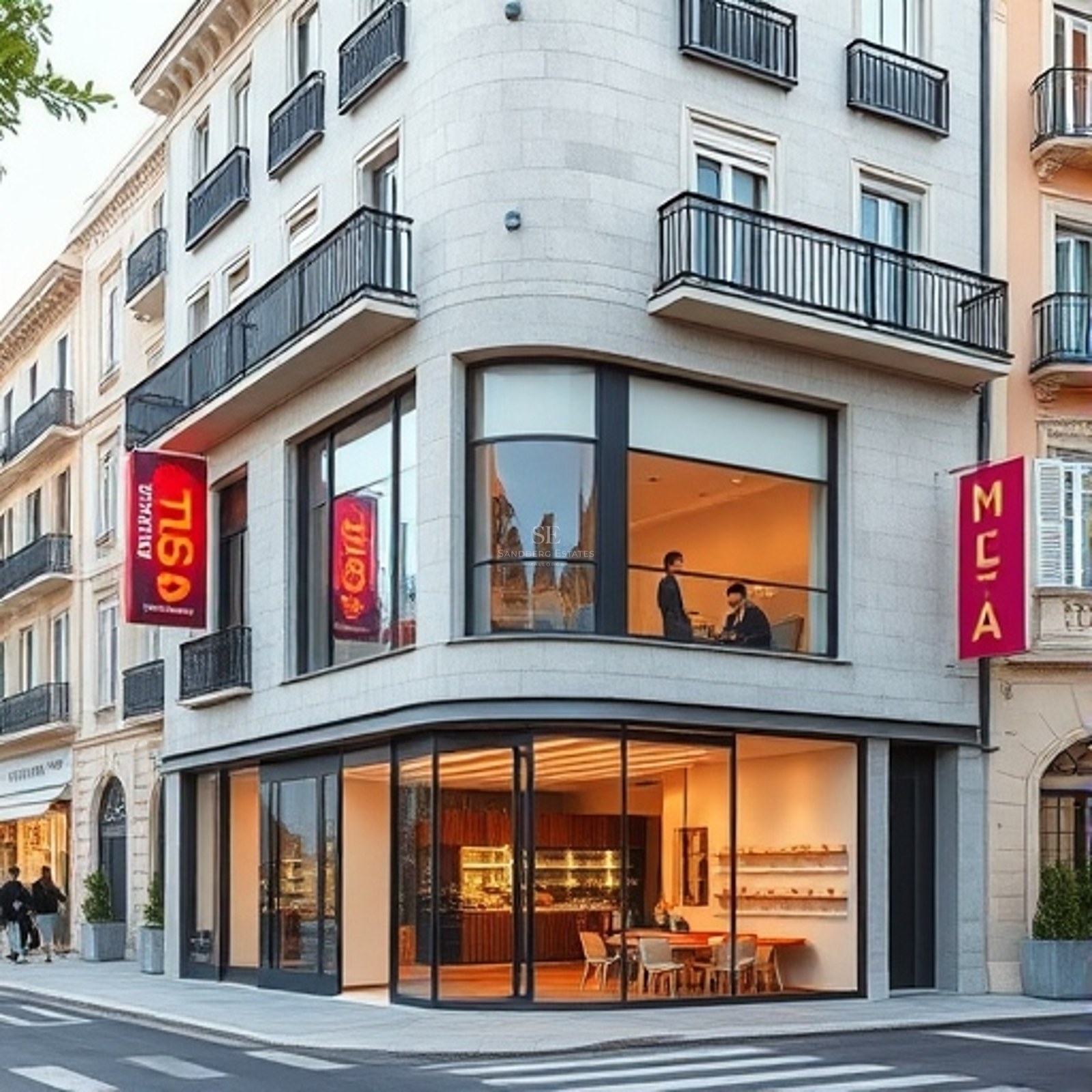 Corner view of a classic stone building with modern expansive glass storefronts and wrought iron balconies.