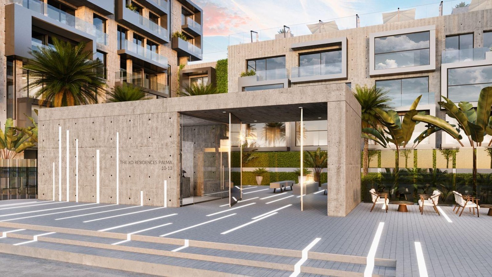 Modern exposed concrete entrance with linear floor lighting and palm trees.