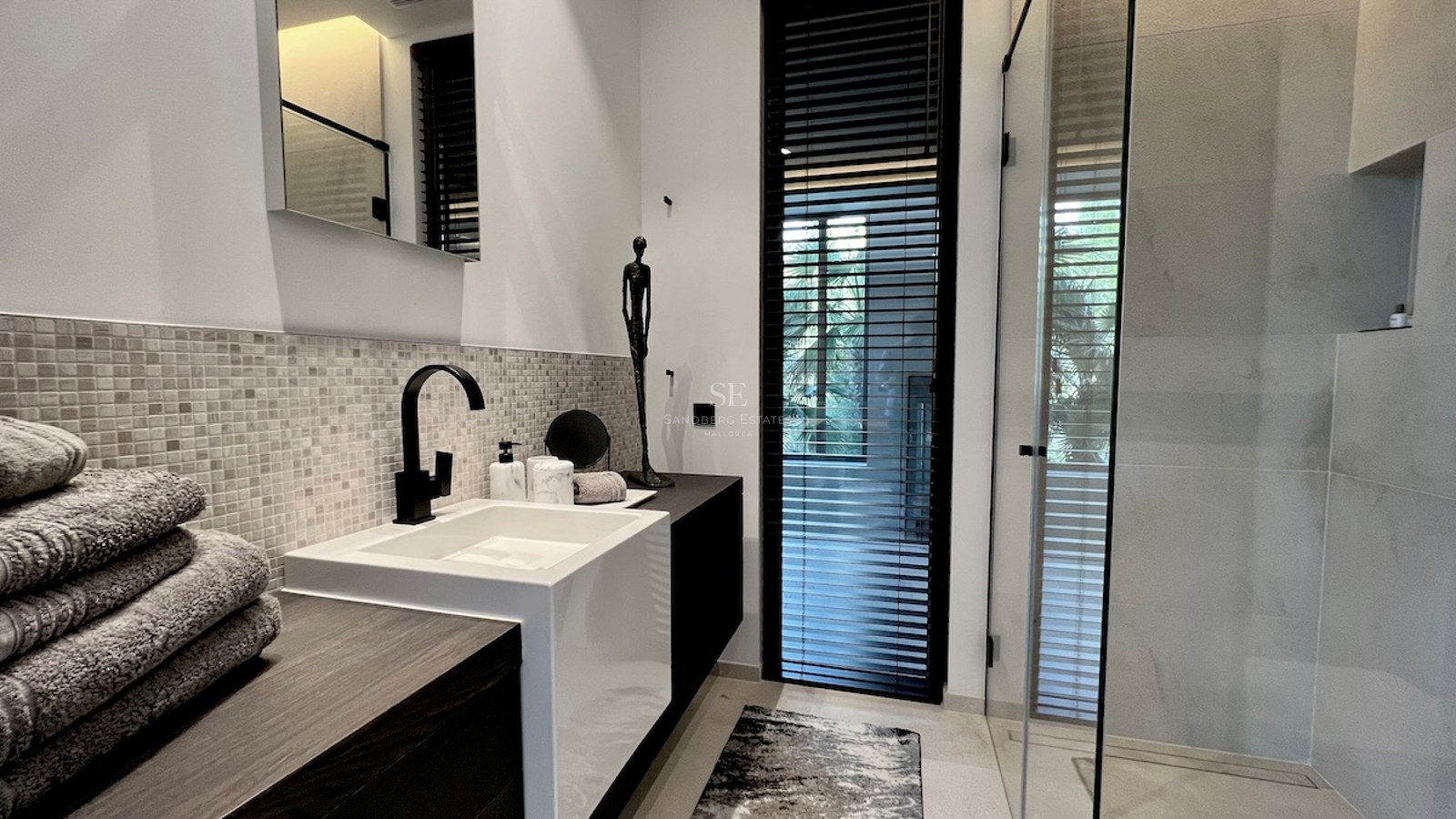Vista exterior de una moderna vivienda con piscina, jardín exuberante y arquitectura minimalista. Iluminación cálida y diseño contemporáneo.