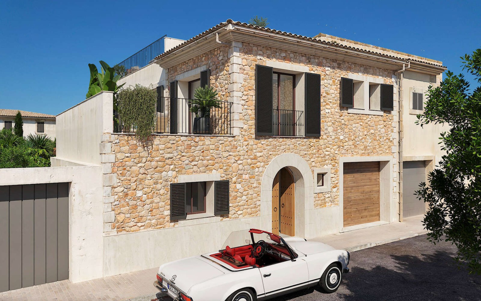 Vue extérieure d'une villa de deux étages en pierre avec volets sombres et cabriolet classique blanc.