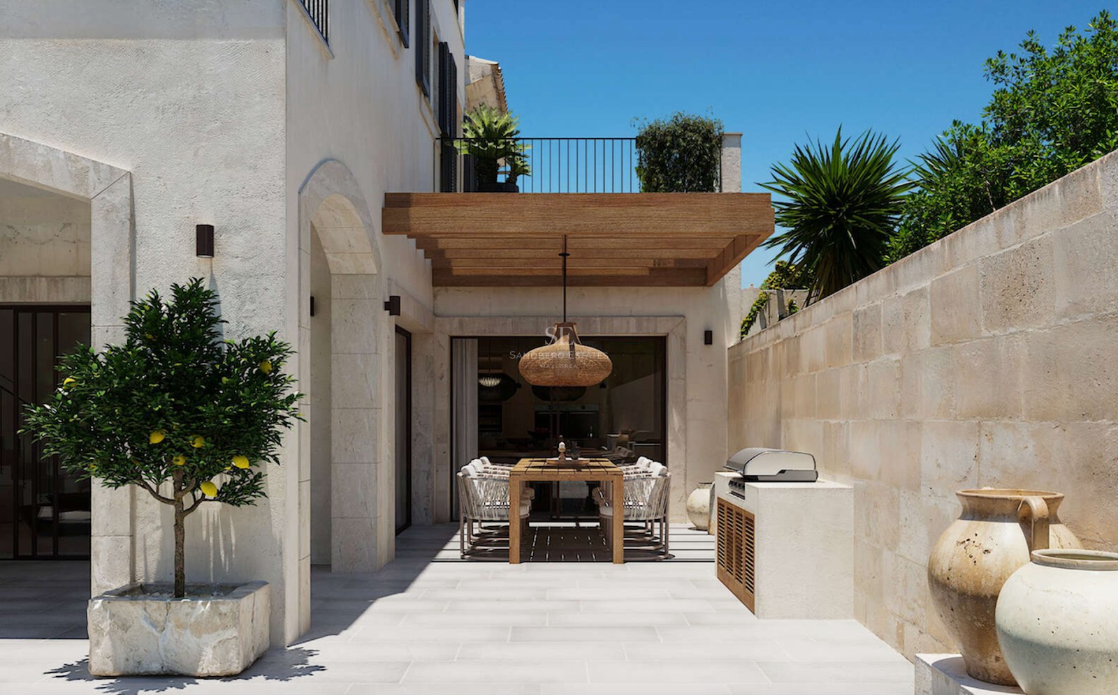 Terrasse extérieure ensoleillée avec pergola en bois, table à manger et barbecue intégré contre des murs en pierre naturelle.
